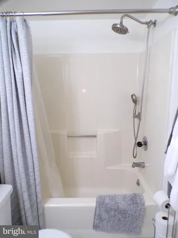 a bathroom with a shower and a bath tub