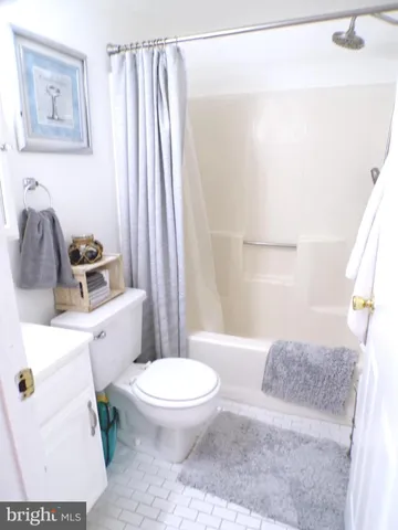 a white toilet sitting next to a bathroom sink and tub
