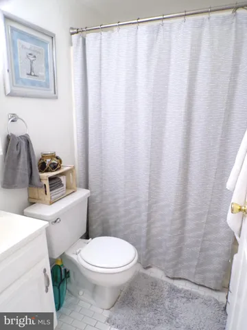 a white toilet sitting next to a small bathroom sink
