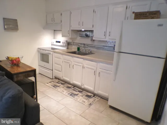 a kitchen with stainless steel appliances granite countertop a refrigerator sink and cabinets