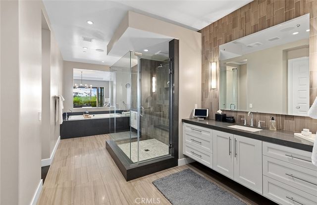 a bathroom with double vanity and a bathtub