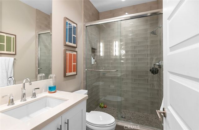 a bathroom with a sink mirror toilet and shower