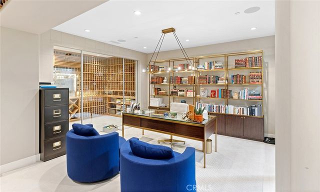 a living room with furniture a chandelier and a floor to ceiling window