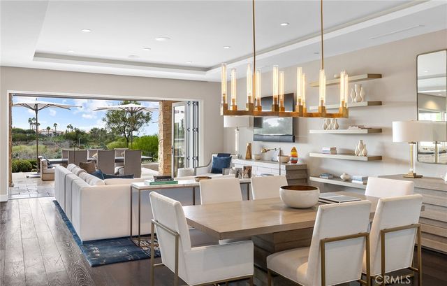 a kitchen with a table chairs and flat screen tv