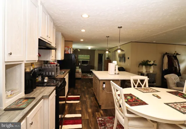 a kitchen with a table chairs and a dining table