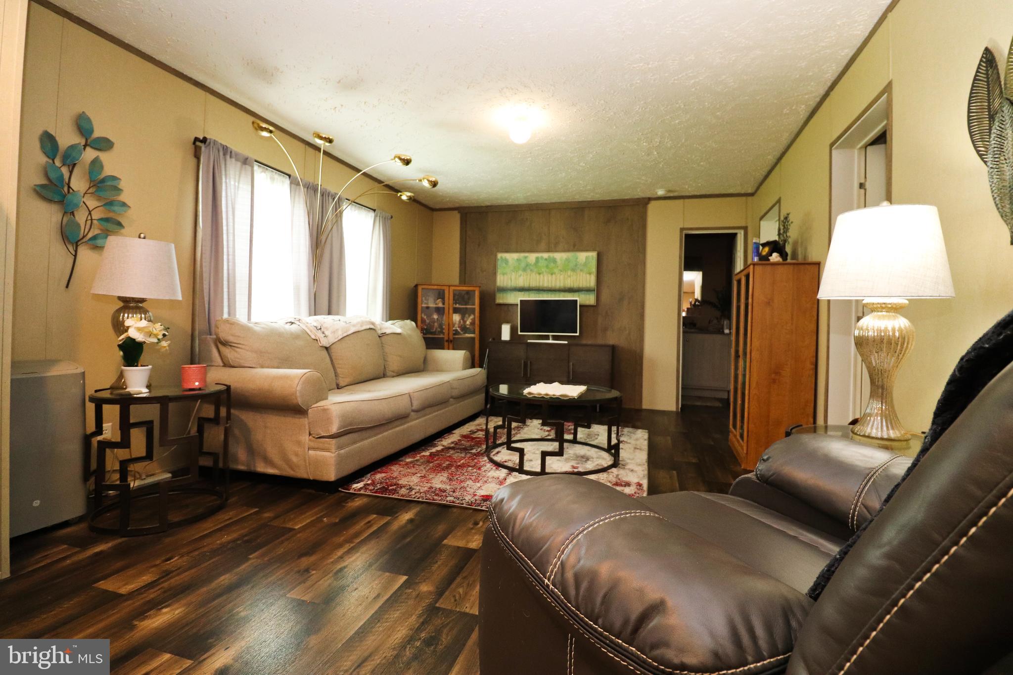 11276 Hodson White Road Deal Island, MD 21821 - Photo 15 of 27 a living room with furniture and a large window