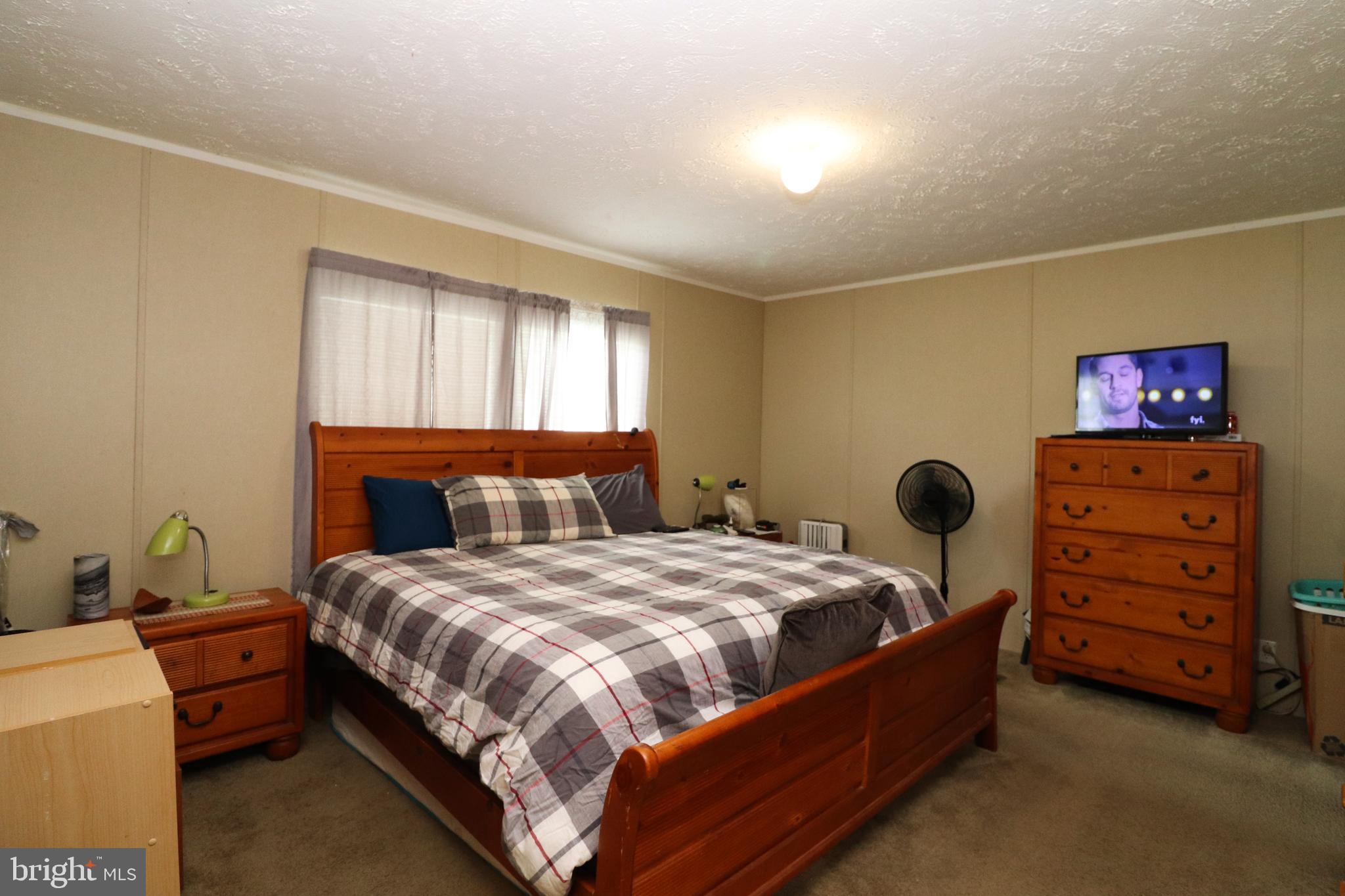 11276 Hodson White Road Deal Island, MD 21821 - Photo 18 of 27 a bedroom with a bed and a closet