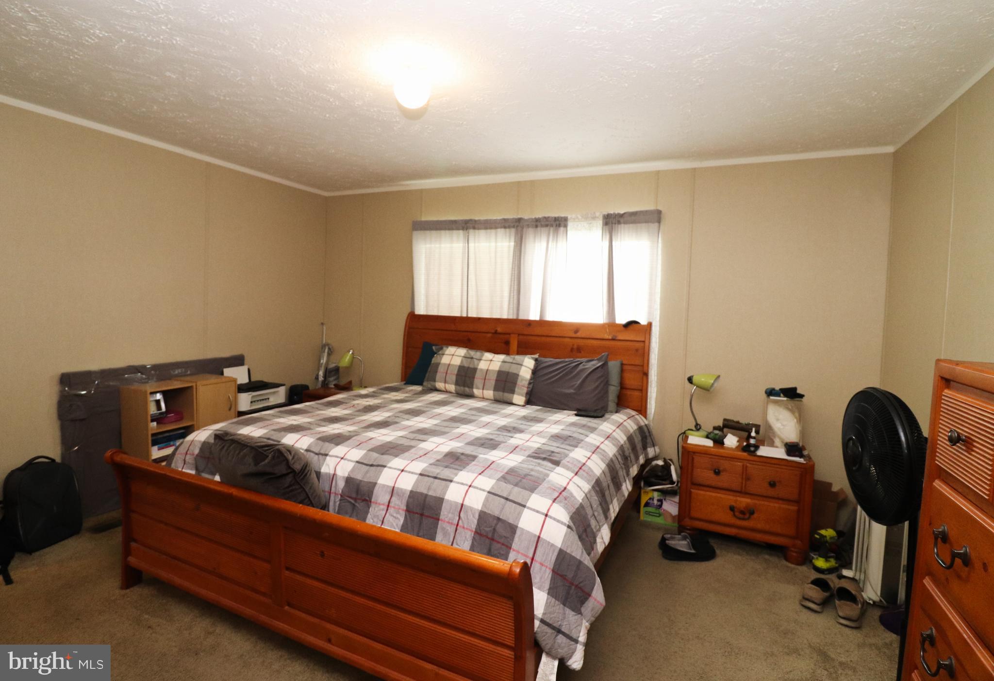 11276 Hodson White Road Deal Island, MD 21821 - Photo 19 of 27 a bedroom with a bed and a chair