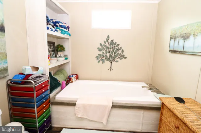 a bedroom with a bed and a dresser in it