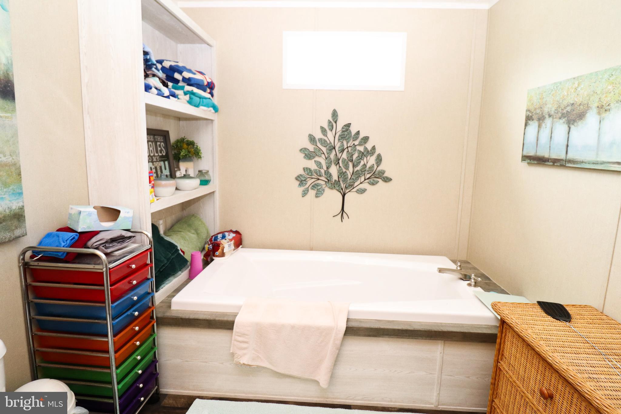 11276 Hodson White Road Deal Island, MD 21821 - Photo 21 of 27 a bedroom with a bed and a dresser in it