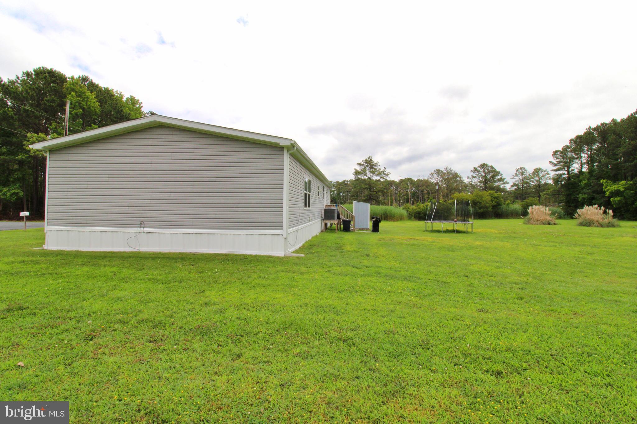 11276 Hodson White Road Deal Island, MD 21821 - Photo 23 of 27 a backyard of a house with lots of green space