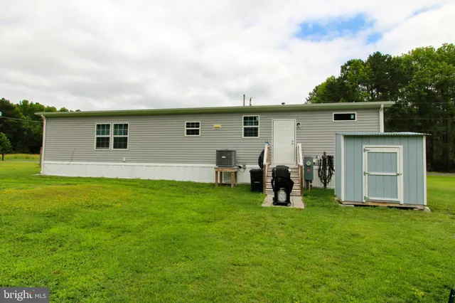 a house view with swimming pool and green space