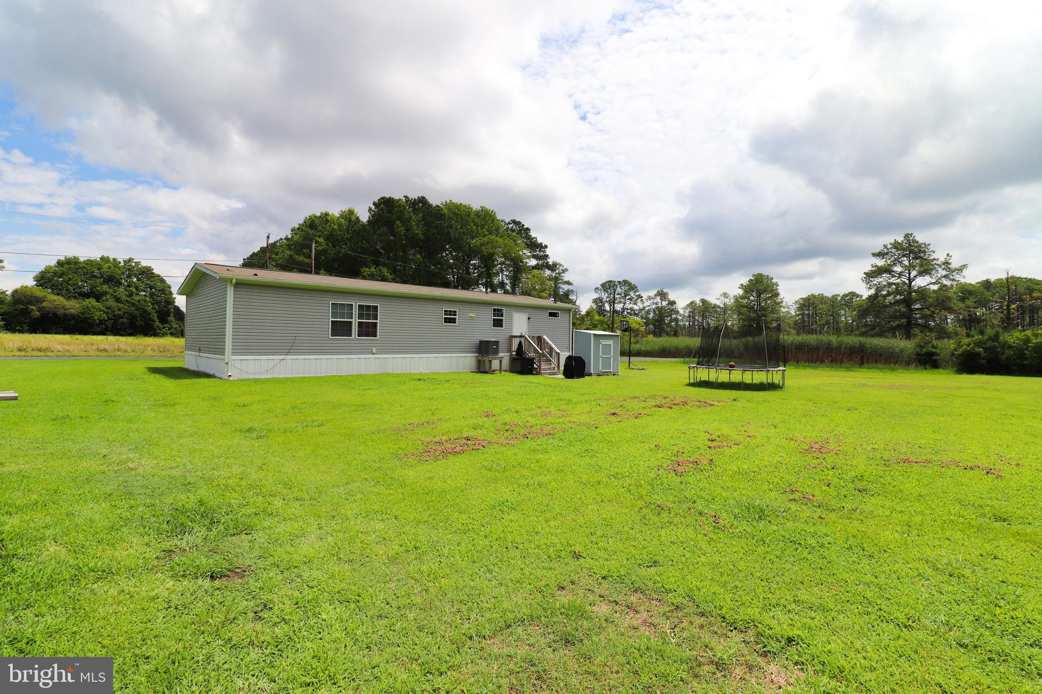 11276 Hodson White Road Deal Island, MD 21821 - Photo 26 of 27 a house view with swimming pool and green space