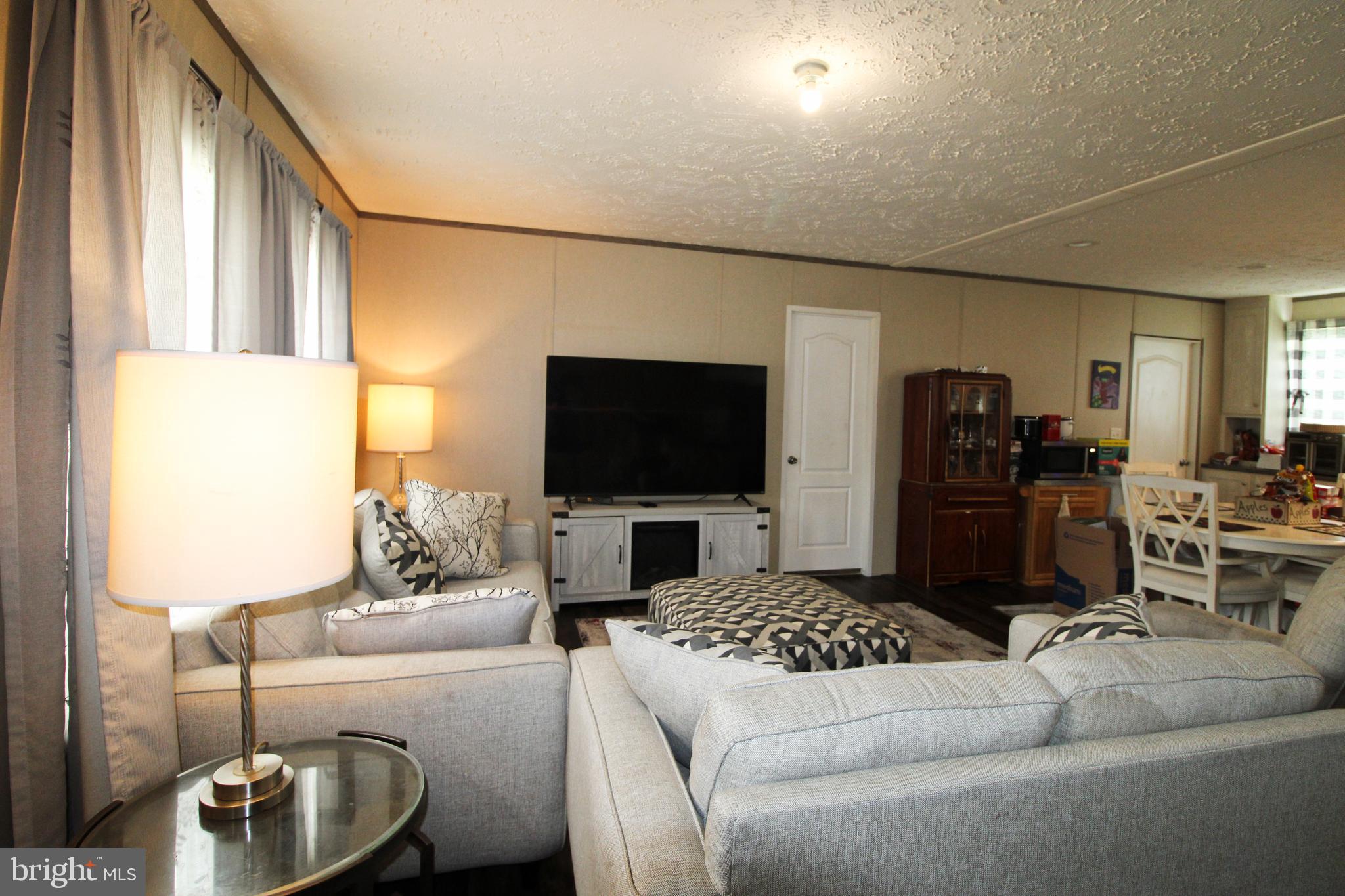 11276 Hodson White Road Deal Island, MD 21821 - Photo 3 of 27 a living room with furniture and a flat screen tv