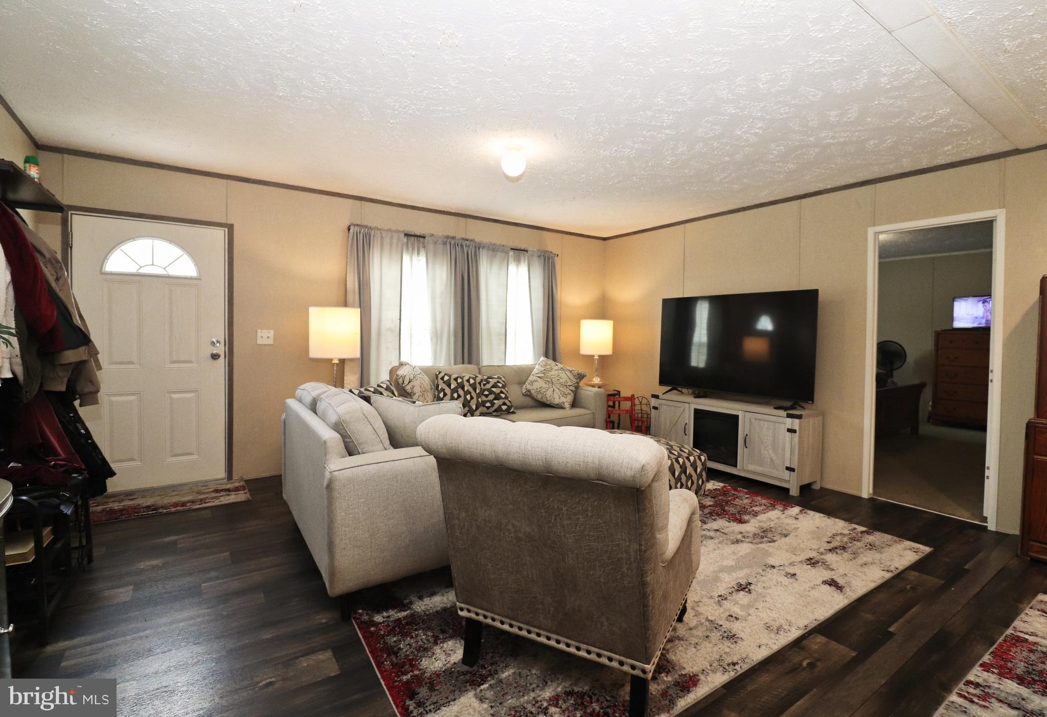 11276 Hodson White Road Deal Island, MD 21821 - Photo 6 of 27 a living room with furniture and a flat screen tv