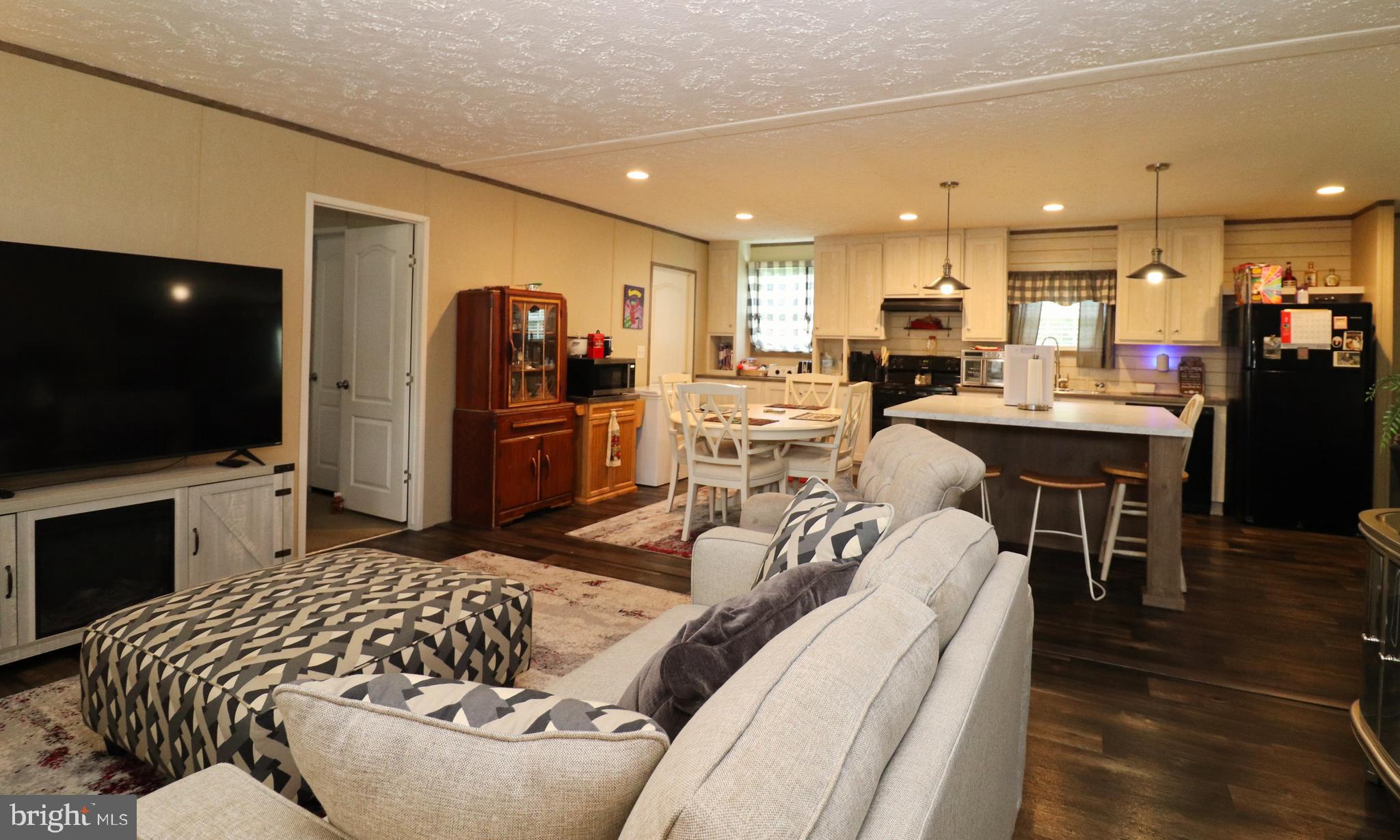 11276 Hodson White Road Deal Island, MD 21821 - Photo 7 of 27 a living room with furniture and a flat screen tv