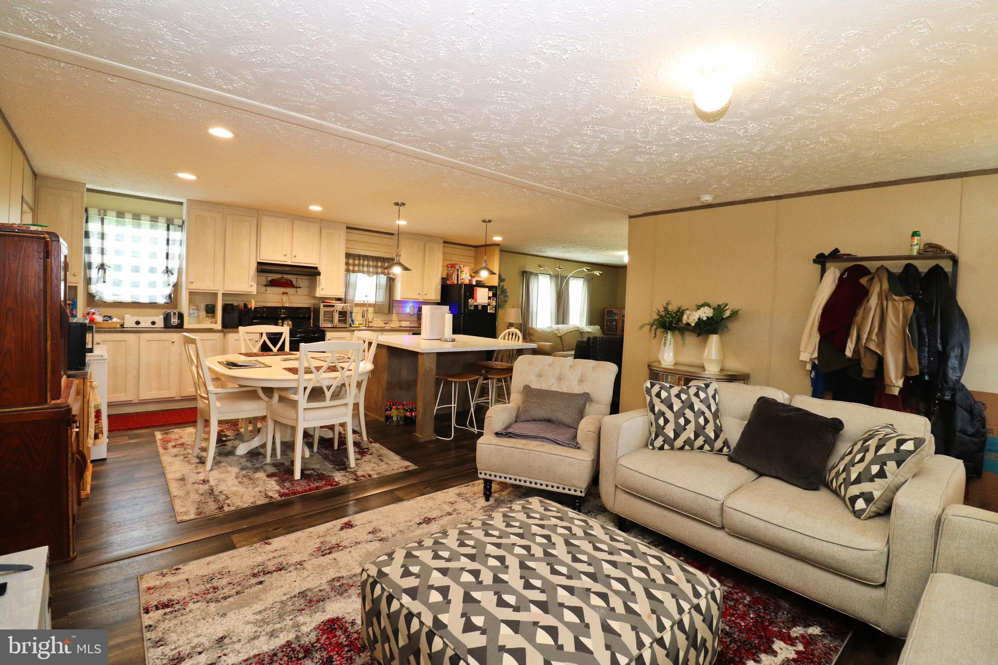 11276 Hodson White Road Deal Island, MD 21821 - Photo 8 of 27 a living room with lots of furniture and a rug