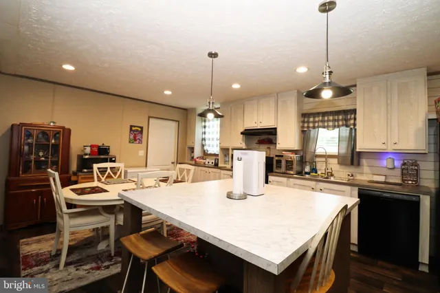 a kitchen with a dining table and chairs