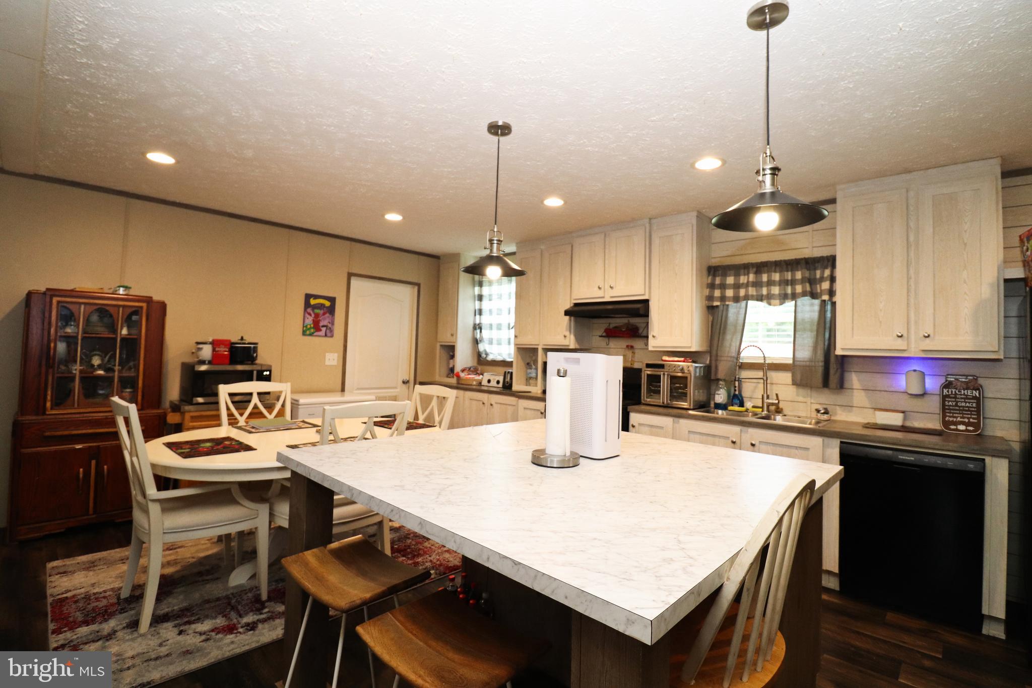 11276 Hodson White Road Deal Island, MD 21821 - Photo 10 of 27 a kitchen with a dining table and chairs