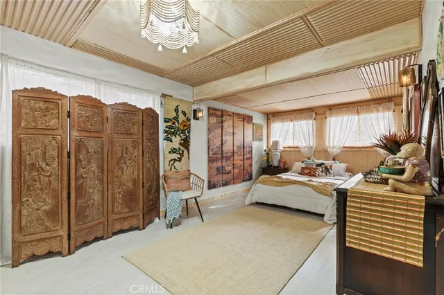 a bed room with a bed window and a table