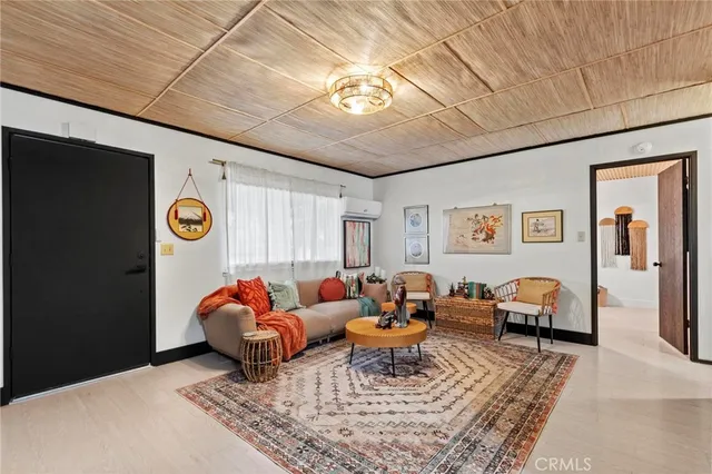 a living room with furniture a rug and a window