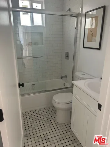 a bathroom with a toilet a sink and a shower