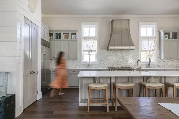 a kitchen with cabinets and wooden floor