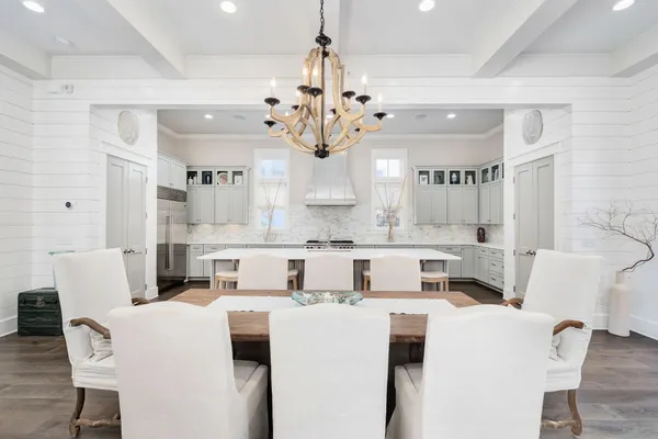 a view of a dining room with furniture and a chandelier