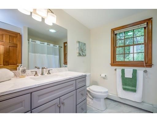25 Farm Road Stow, MA 01775 - Photo 17 of 22 a bathroom with a sink a toilet a mirror and a window