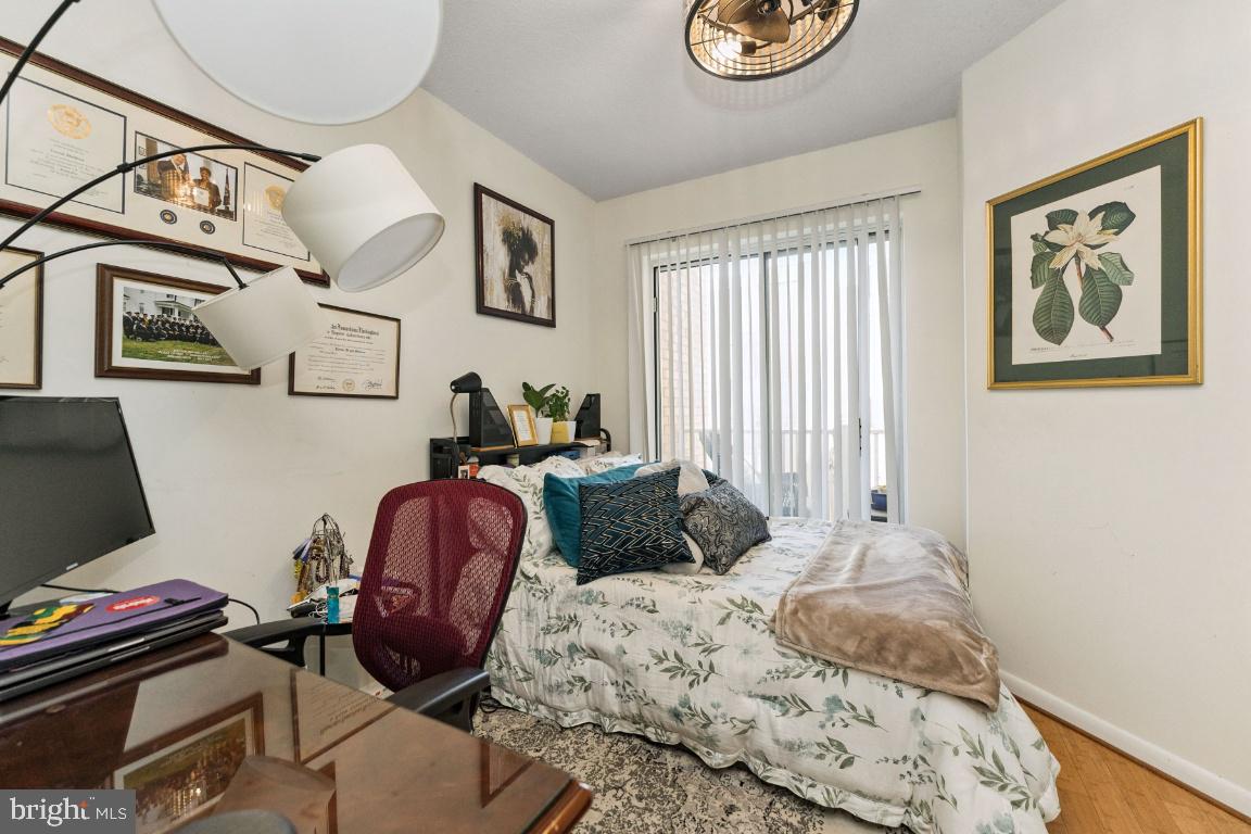 1111 11th Street Northwest, Unit 408 Washington, DC 20001 - Photo 12 of 18 a bedroom with furniture and a window