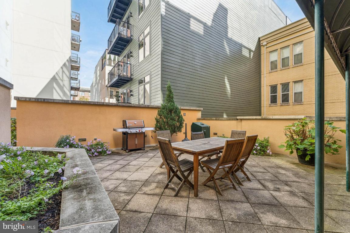 1111 11th Street Northwest, Unit 408 Washington, DC 20001 - Photo 16 of 18 a backyard of a house with table and chairs