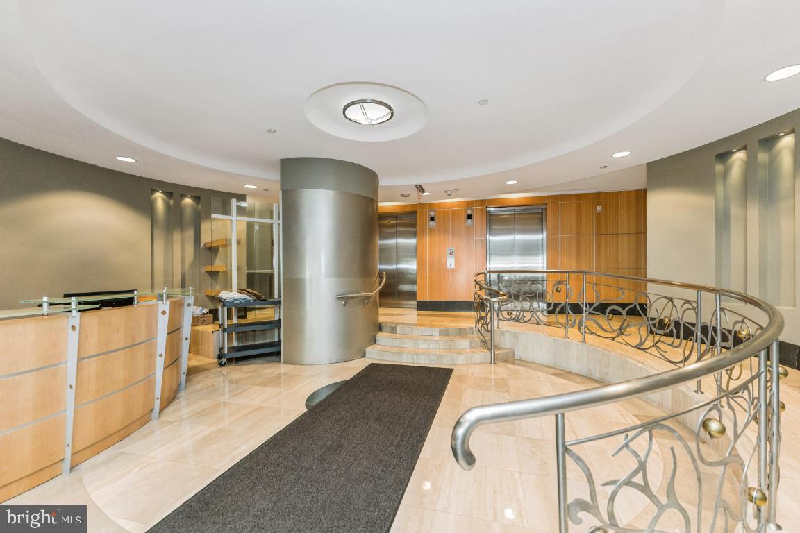 1111 11th Street Northwest, Unit 408 Washington, DC 20001 - Photo 3 of 18 a large kitchen with kitchen island a large counter top space a sink and stainless steel appliances