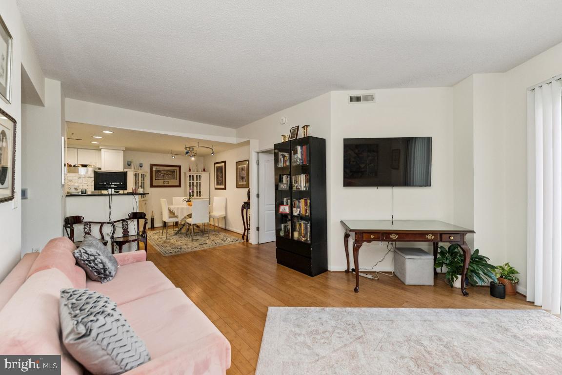 1111 11th Street Northwest, Unit 408 Washington, DC 20001 - Photo 4 of 18 a living room with furniture and wooden floor