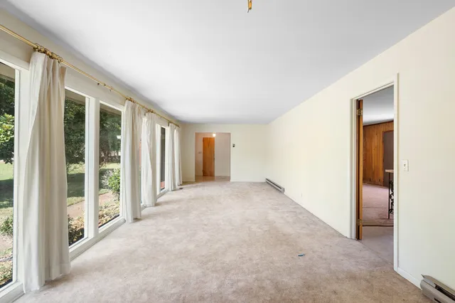 a view of an empty room with glass door