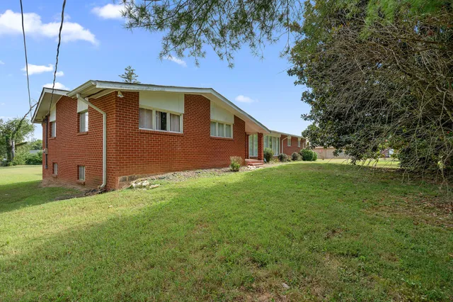 a front view of house with yard and trees