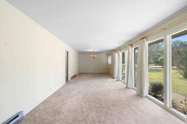 a view of an empty room with glass door