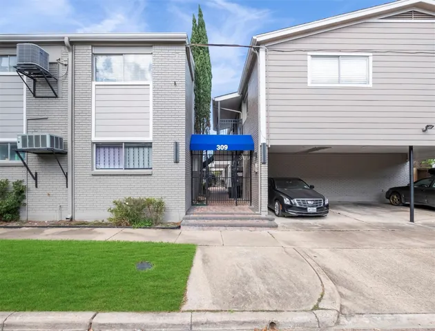 a view of a car park in front of house