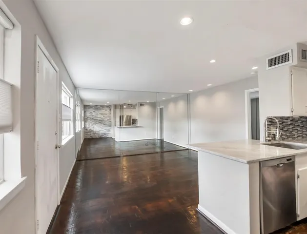 a view of a kitchen with a sink and cabinets