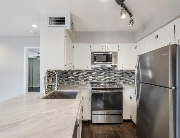 a kitchen with a refrigerator sink and stove