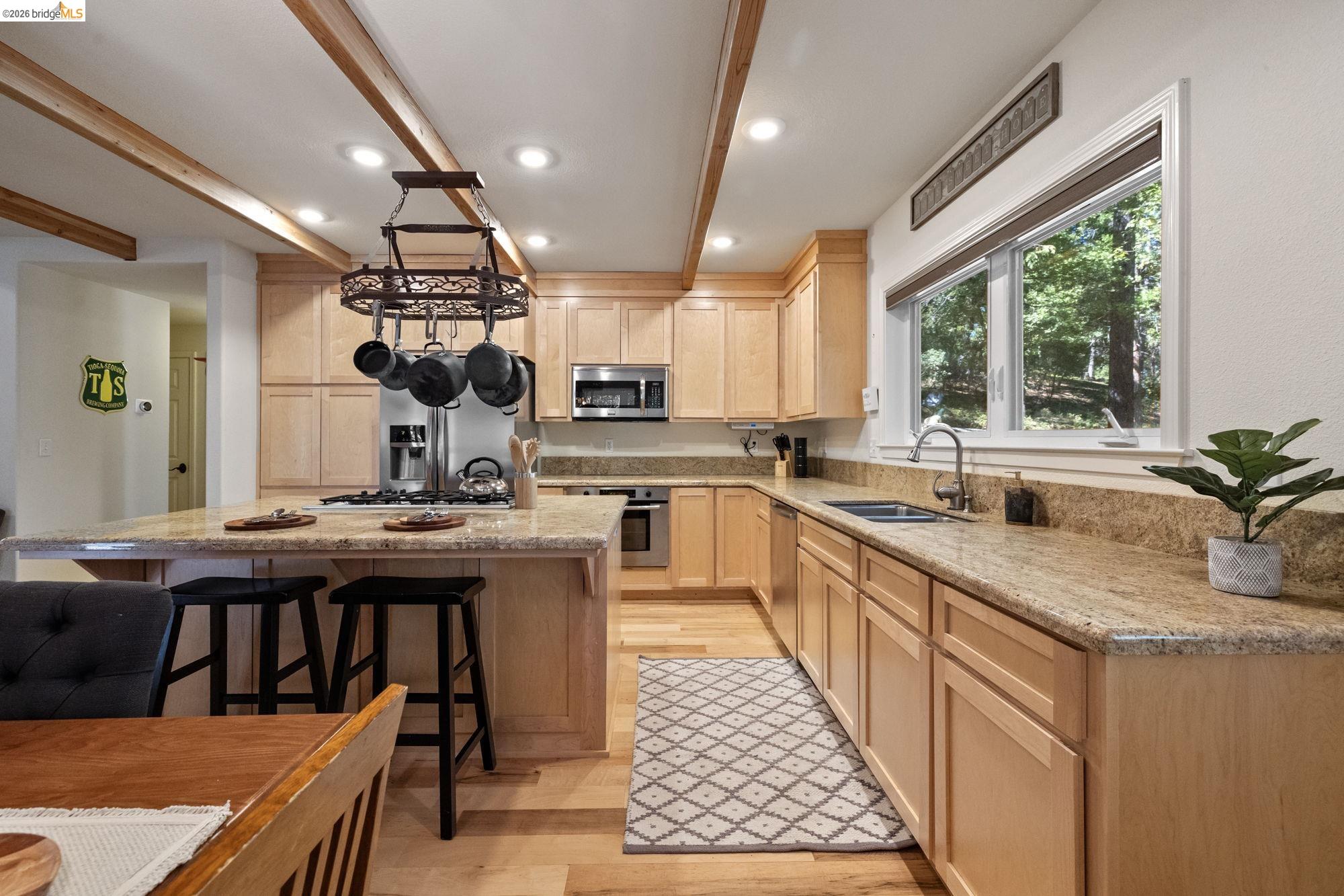 24669 Center Camp Road Twain Harte, CA 95383 - Photo 12 of 33 a kitchen with stainless steel appliances granite countertop a sink stove and cabinets