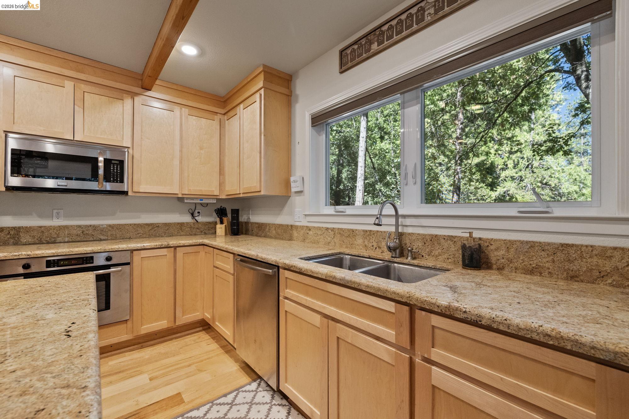 24669 Center Camp Road Twain Harte, CA 95383 - Photo 13 of 33 a kitchen with granite countertop a sink window and cabinets