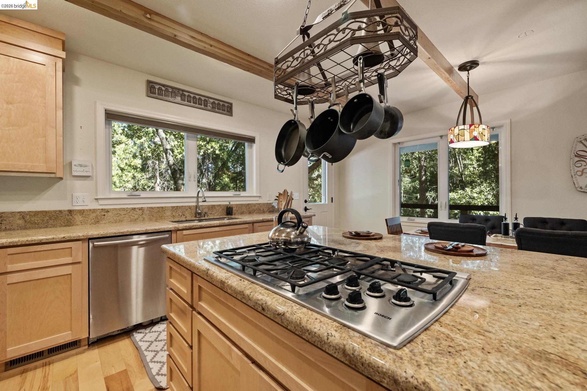 24669 Center Camp Road Twain Harte, CA 95383 - Photo 14 of 33 a kitchen with a stove a window cabinets and stainless steel appliances