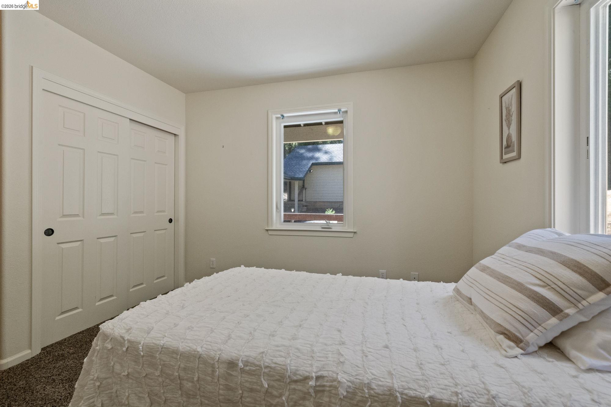 24669 Center Camp Road Twain Harte, CA 95383 - Photo 16 of 33 a bedroom with a bed and a window