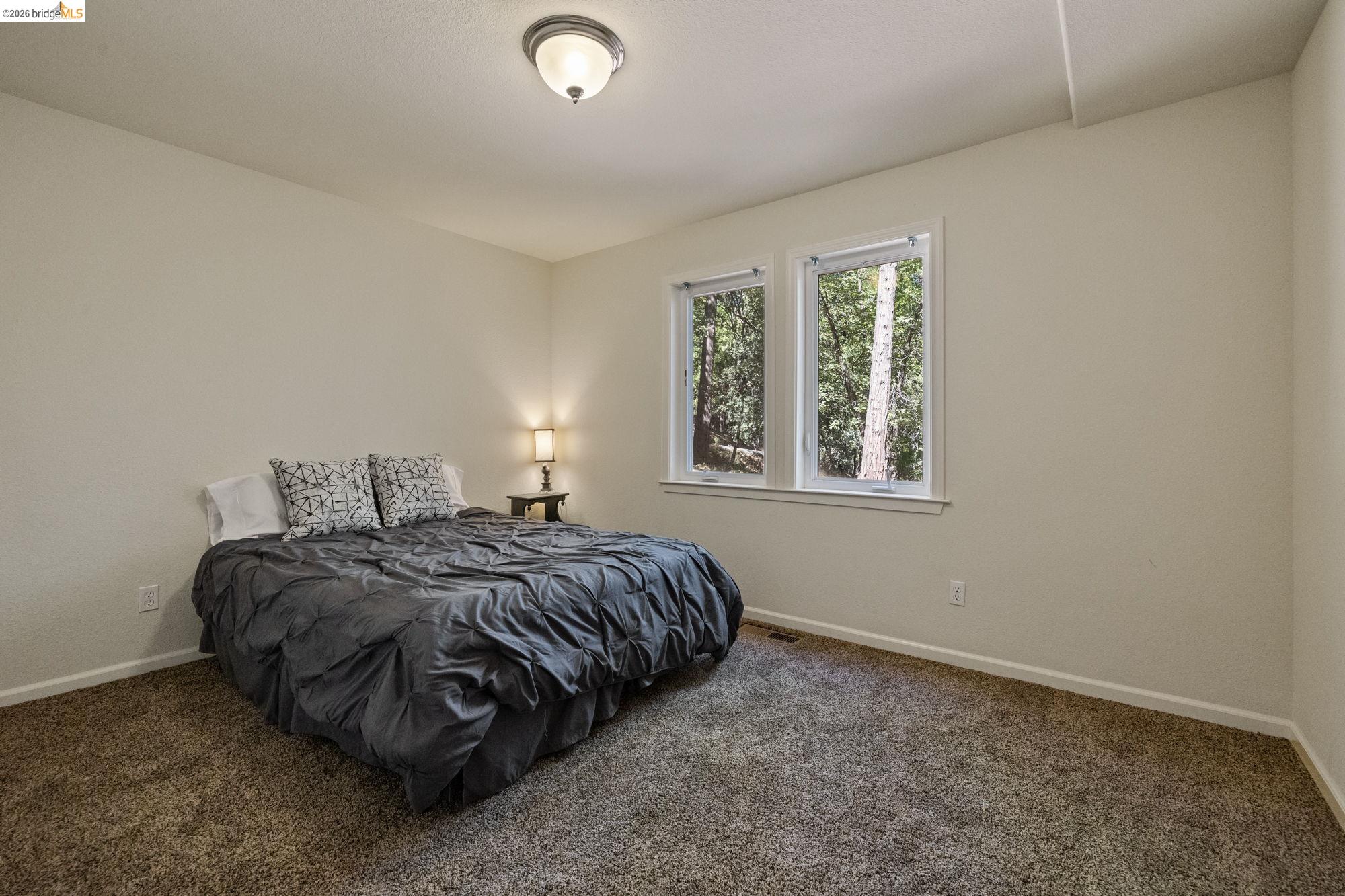 24669 Center Camp Road Twain Harte, CA 95383 - Photo 17 of 33 a bedroom with a bed and window