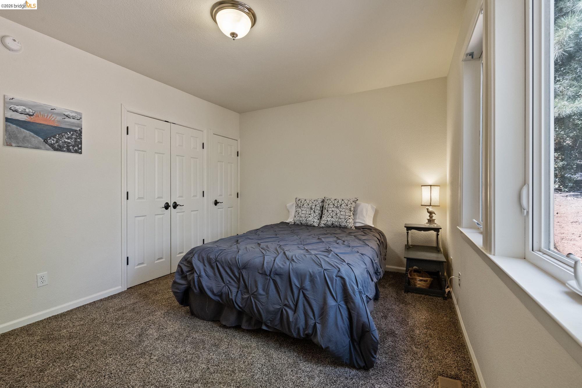 24669 Center Camp Road Twain Harte, CA 95383 - Photo 18 of 33 a spacious bedroom with a bed and a window