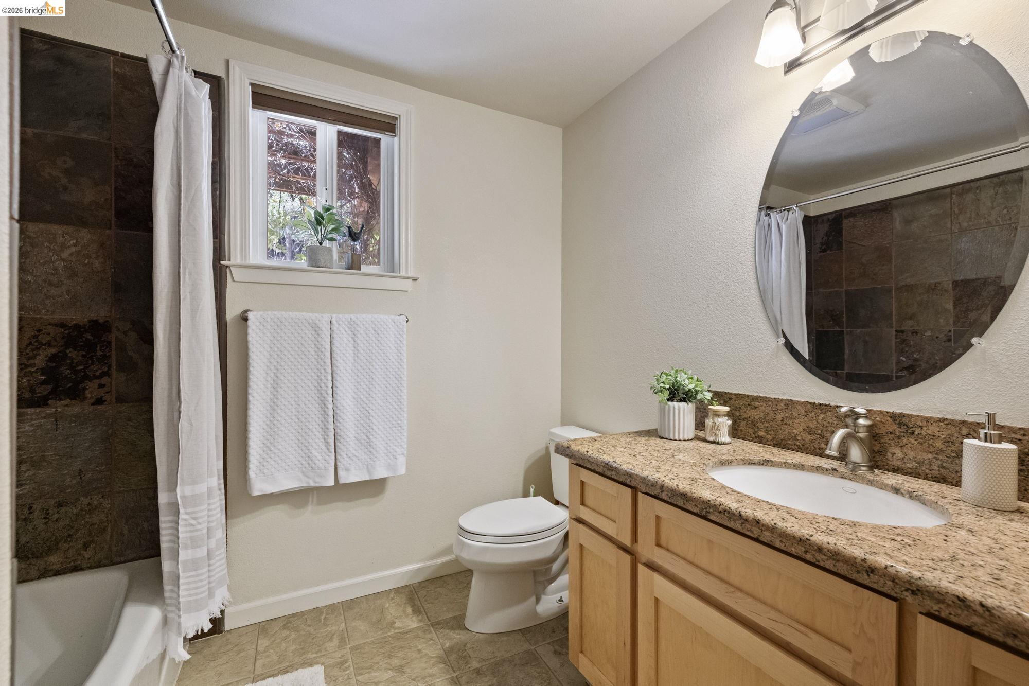 24669 Center Camp Road Twain Harte, CA 95383 - Photo 19 of 33 a bathroom with a granite countertop toilet sink and mirror