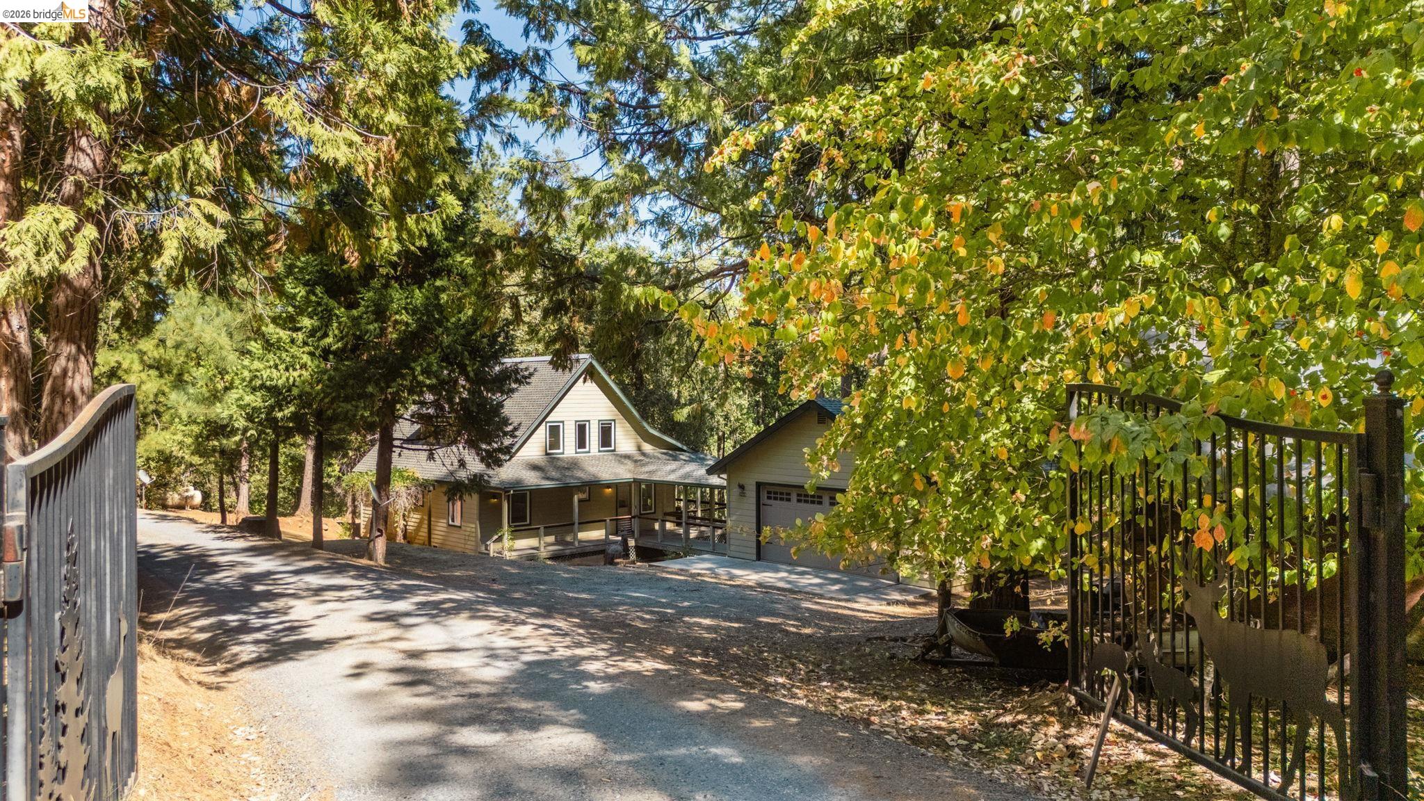 24669 Center Camp Road Twain Harte, CA 95383 - Photo 2 of 33 a front view of a house with a yard