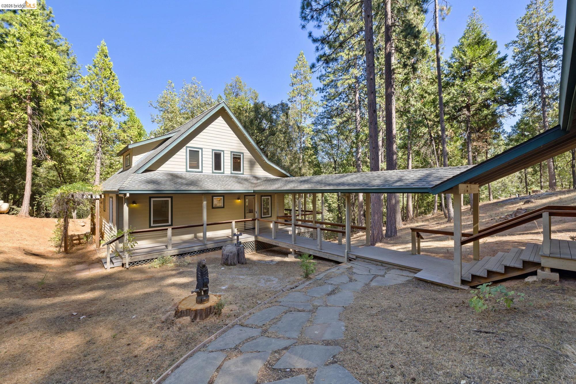 24669 Center Camp Road Twain Harte, CA 95383 - Photo 3 of 33 a view of a house with backyard porch and sitting area