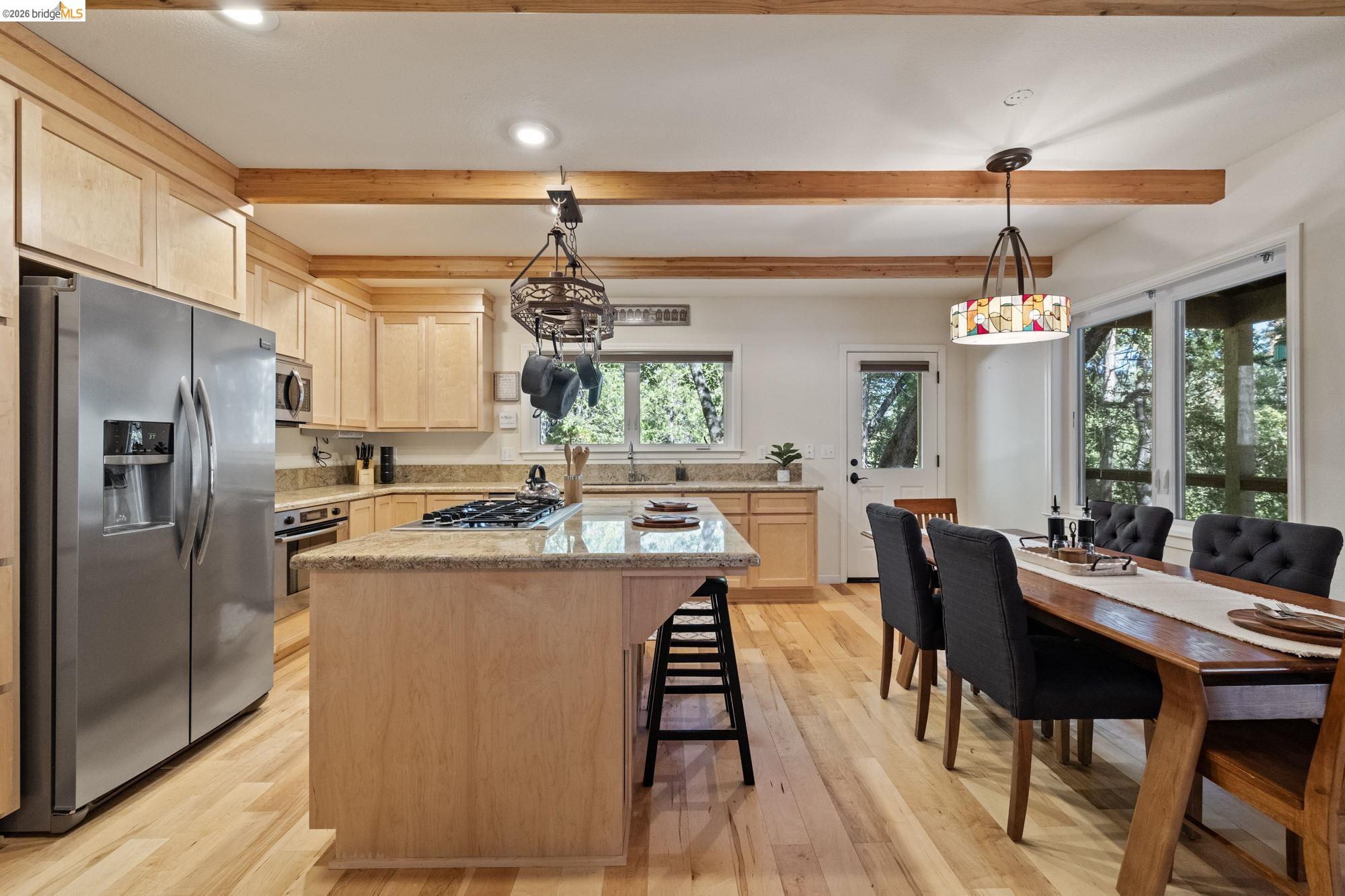 24669 Center Camp Road Twain Harte, CA 95383 - Photo 9 of 33 a kitchen with counter top space dining table and stainless steel appliances