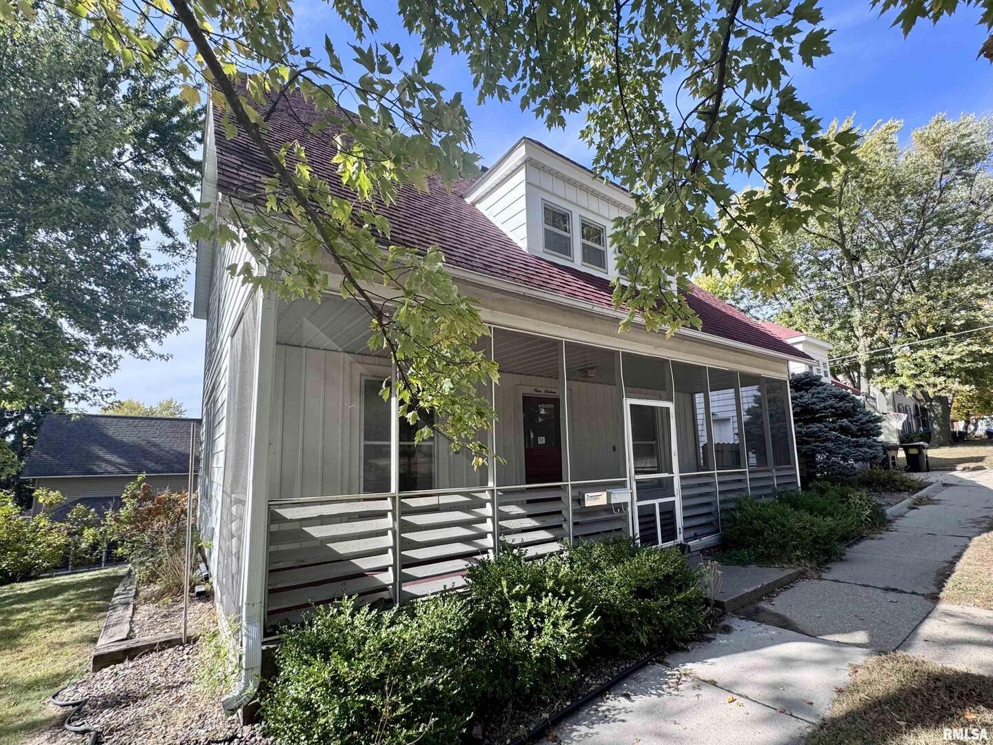 front view of a house with a tree